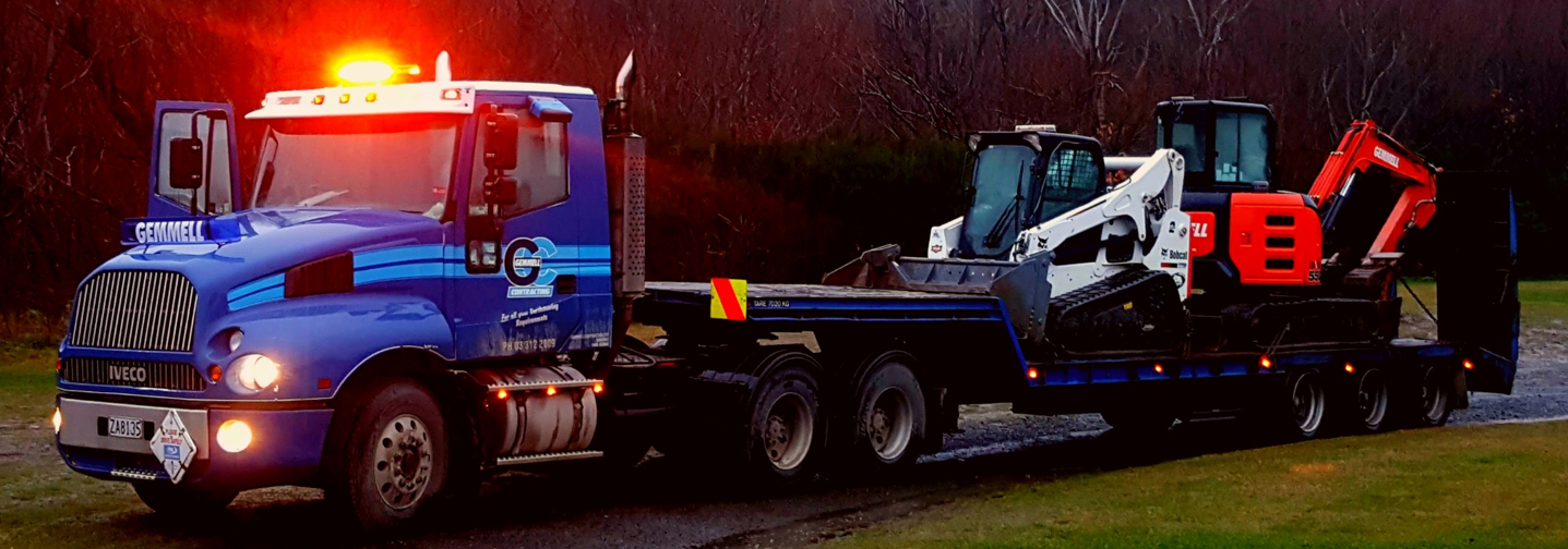 truck transporting earthmoving equipment